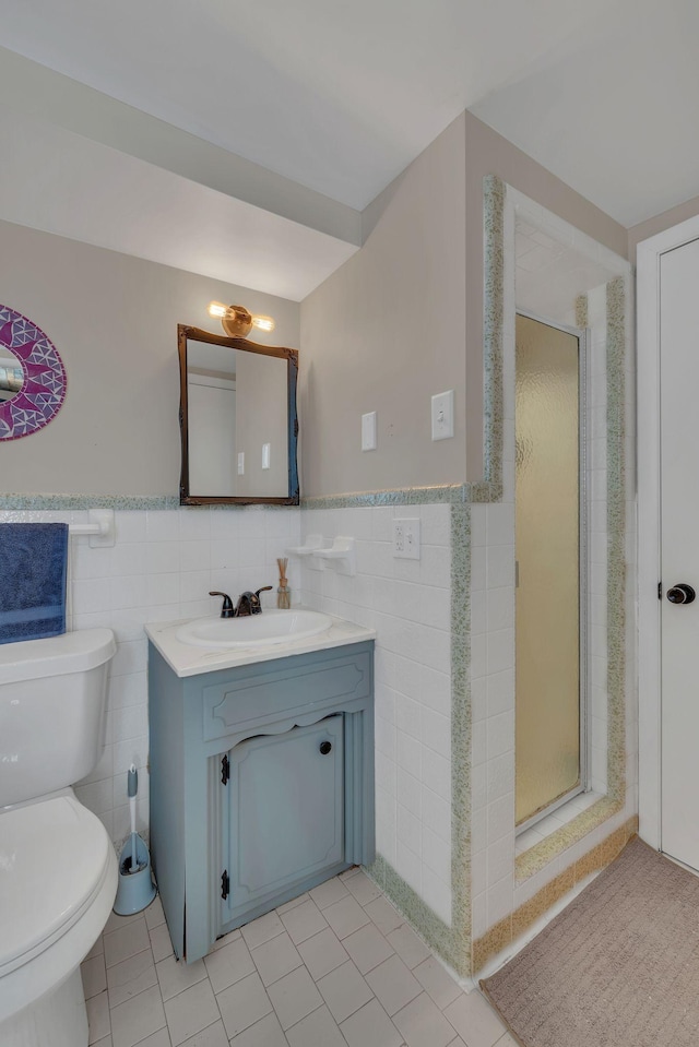 bathroom featuring tile walls, a shower with door, and toilet