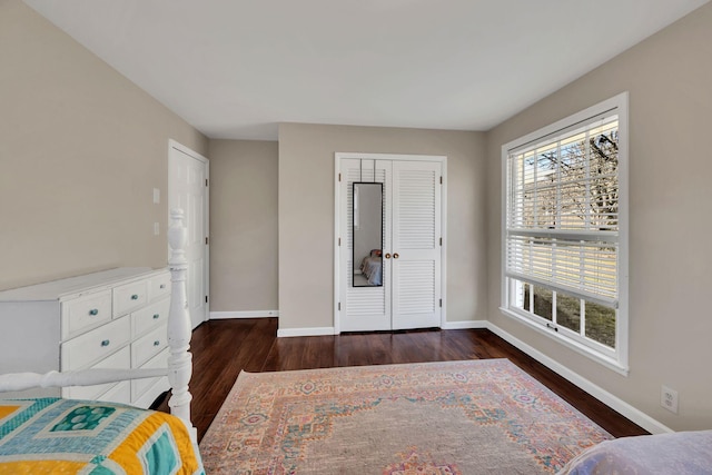 bedroom featuring dark hardwood / wood-style floors and a closet