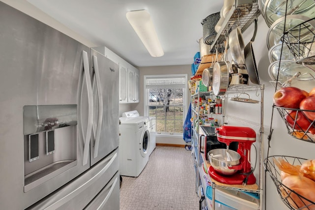 washroom with cabinets and washer and clothes dryer