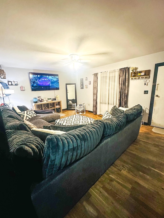 living room featuring hardwood / wood-style floors and ceiling fan