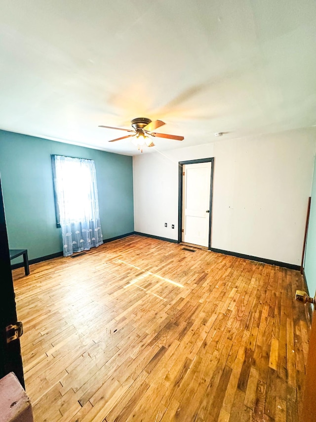 spare room featuring ceiling fan and light wood-type flooring