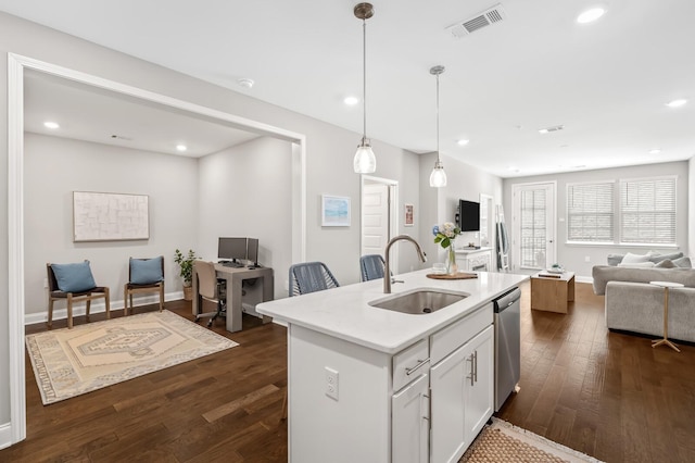 kitchen with pendant lighting, sink, a kitchen island with sink, white cabinetry, and stainless steel dishwasher