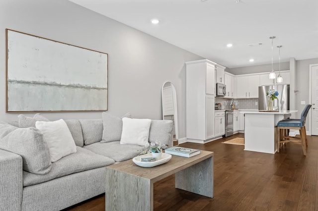 living room with dark hardwood / wood-style flooring