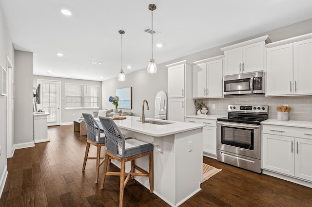 kitchen with appliances with stainless steel finishes, sink, and white cabinets