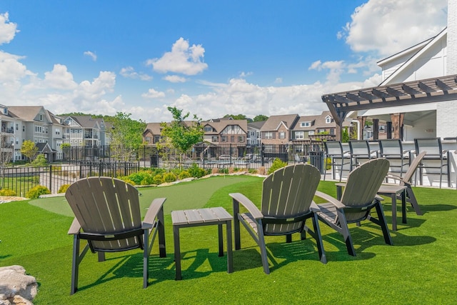 surrounding community with a yard and exterior bar