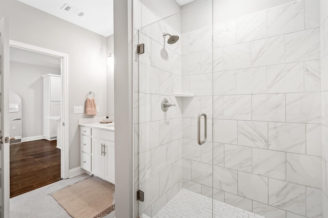 bathroom with vanity and a shower with door