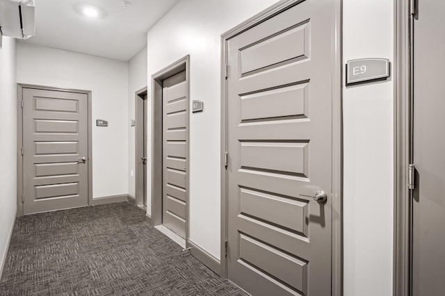 hallway featuring dark carpet