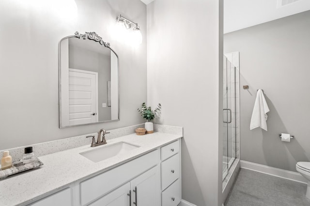 bathroom with vanity, an enclosed shower, and toilet