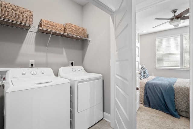 laundry area with washer and dryer, light carpet, and ceiling fan