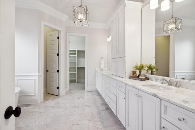 bathroom featuring ornamental molding, a chandelier, and vanity