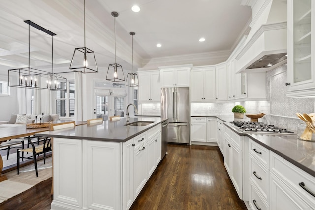 kitchen featuring sink, appliances with stainless steel finishes, hanging light fixtures, white cabinets, and custom exhaust hood