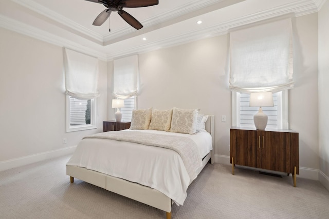 bedroom with a raised ceiling, ornamental molding, light colored carpet, and ceiling fan