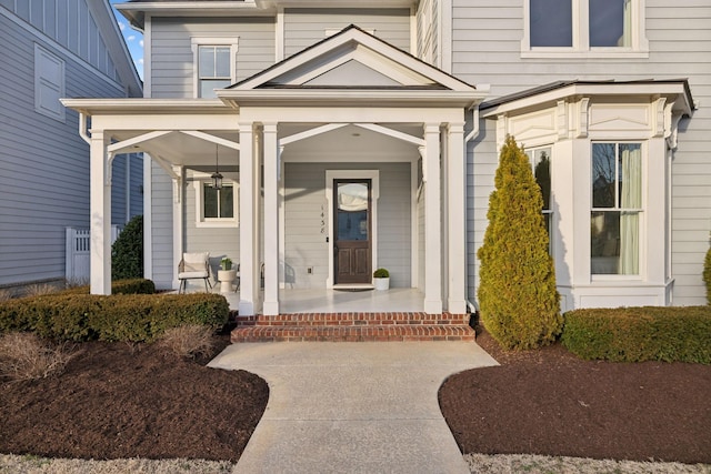 view of exterior entry with a porch