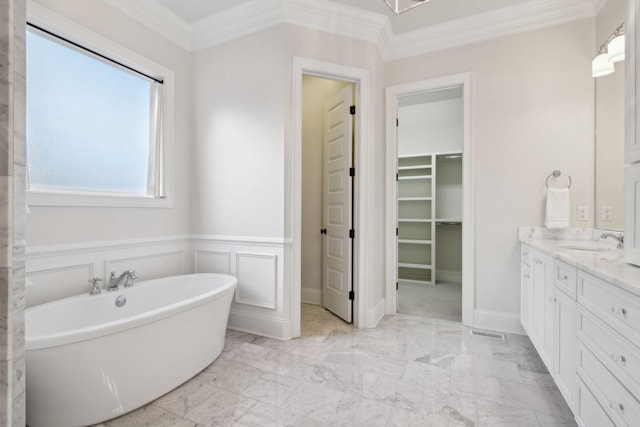 bathroom featuring vanity, ornamental molding, and a washtub