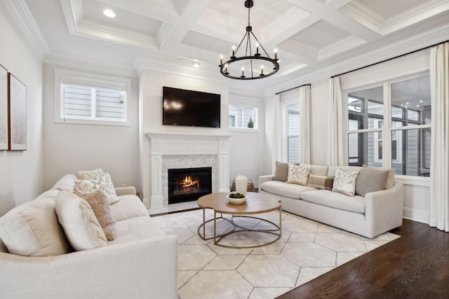 living room featuring beamed ceiling, coffered ceiling, crown molding, and light wood-type flooring