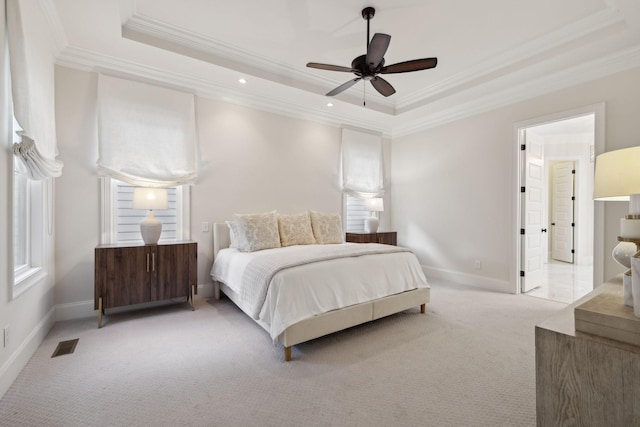 carpeted bedroom featuring ornamental molding, a raised ceiling, and ceiling fan