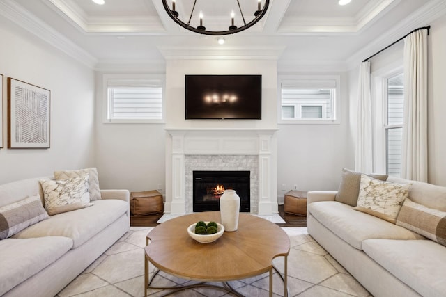 living room with coffered ceiling, crown molding, and an inviting chandelier