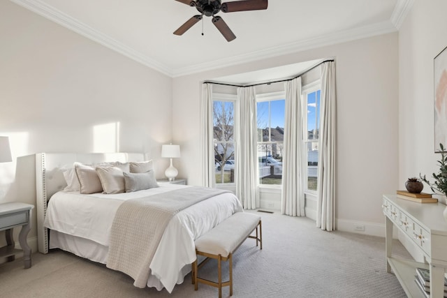 bedroom featuring crown molding, light colored carpet, and ceiling fan