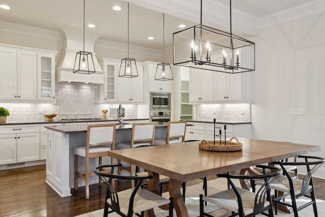 dining space featuring dark hardwood / wood-style flooring and crown molding