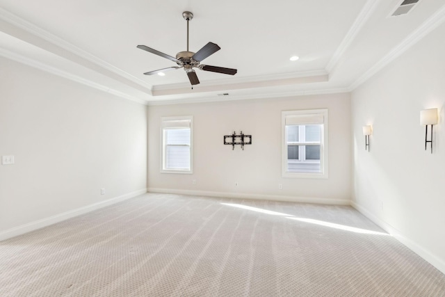 unfurnished room with light carpet, ornamental molding, a raised ceiling, and ceiling fan