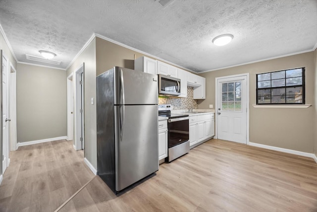 kitchen with white cabinetry, crown molding, stainless steel appliances, light hardwood / wood-style floors, and backsplash