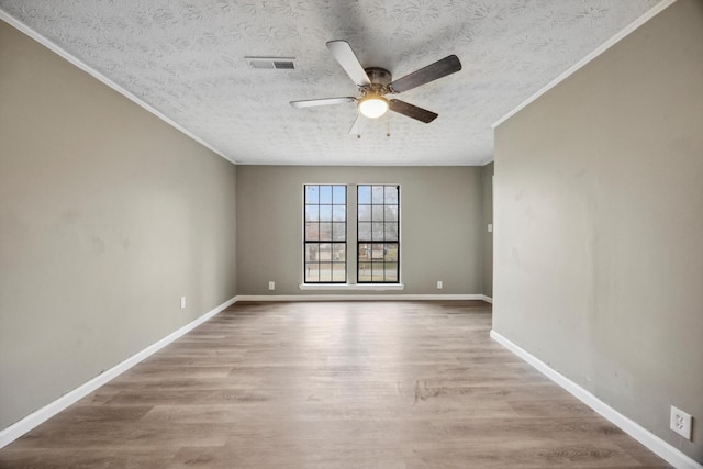 unfurnished room featuring ceiling fan, ornamental molding, a textured ceiling, and light hardwood / wood-style floors