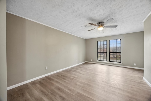 unfurnished room featuring hardwood / wood-style flooring, ceiling fan, and a textured ceiling