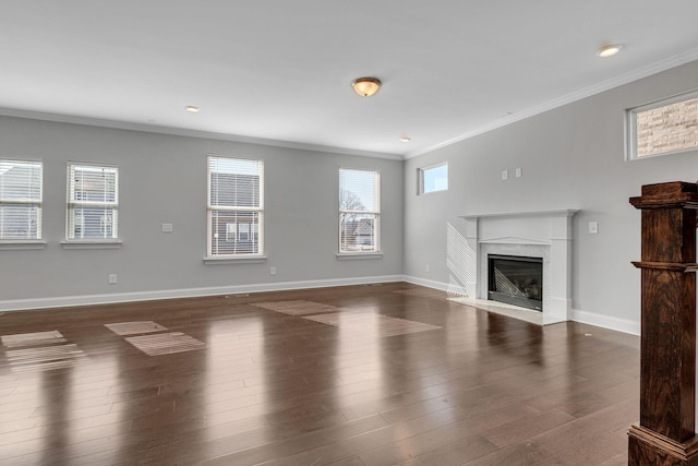 unfurnished living room featuring dark wood-type flooring, a high end fireplace, and crown molding