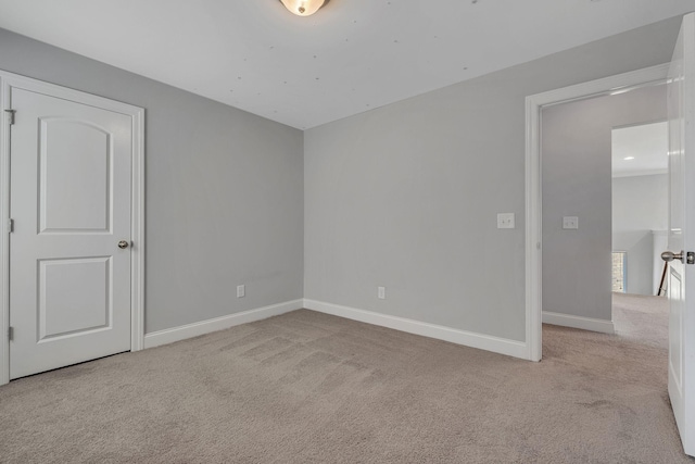 spare room with light colored carpet