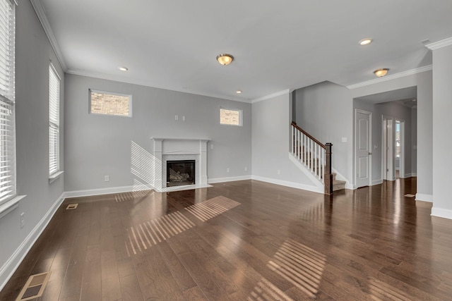 unfurnished living room featuring crown molding, dark wood-type flooring, and a high end fireplace