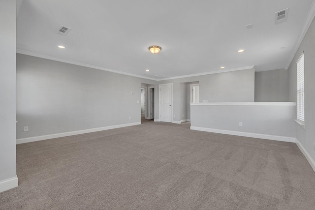 carpeted spare room featuring crown molding