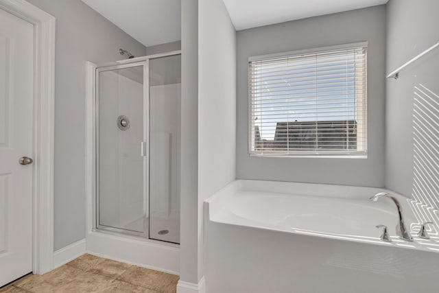 bathroom with tile patterned floors and independent shower and bath