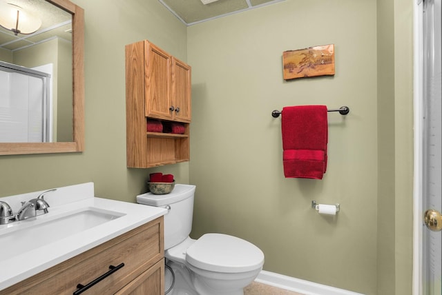 bathroom with a shower with door, vanity, and toilet