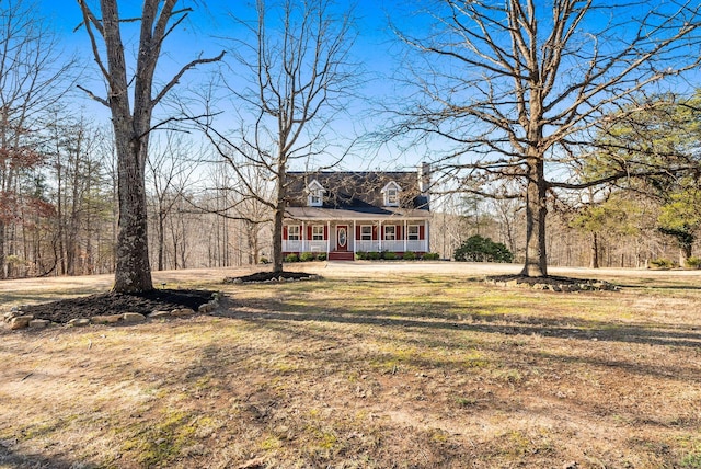 view of front of house with covered porch and a front lawn