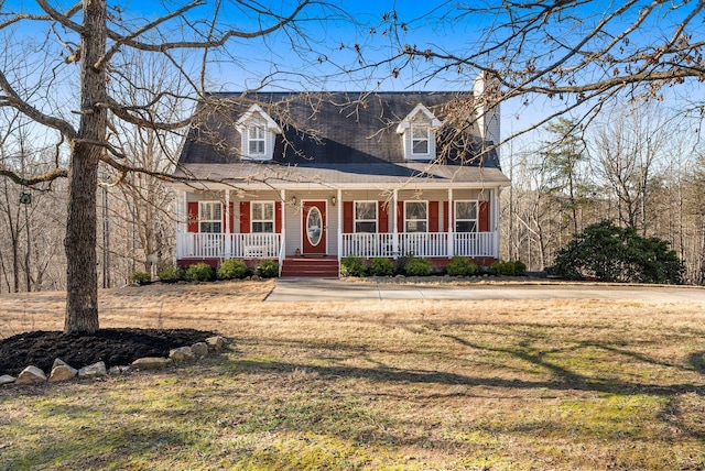 cape cod-style house with a porch and a front yard