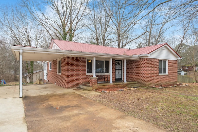 view of front of property featuring a carport and a porch