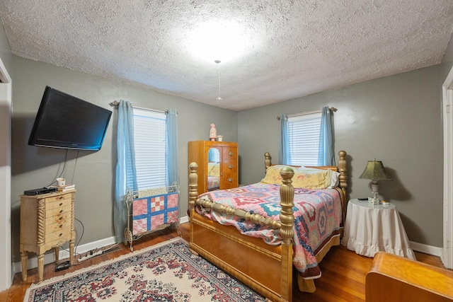 bedroom featuring wood-type flooring and a textured ceiling