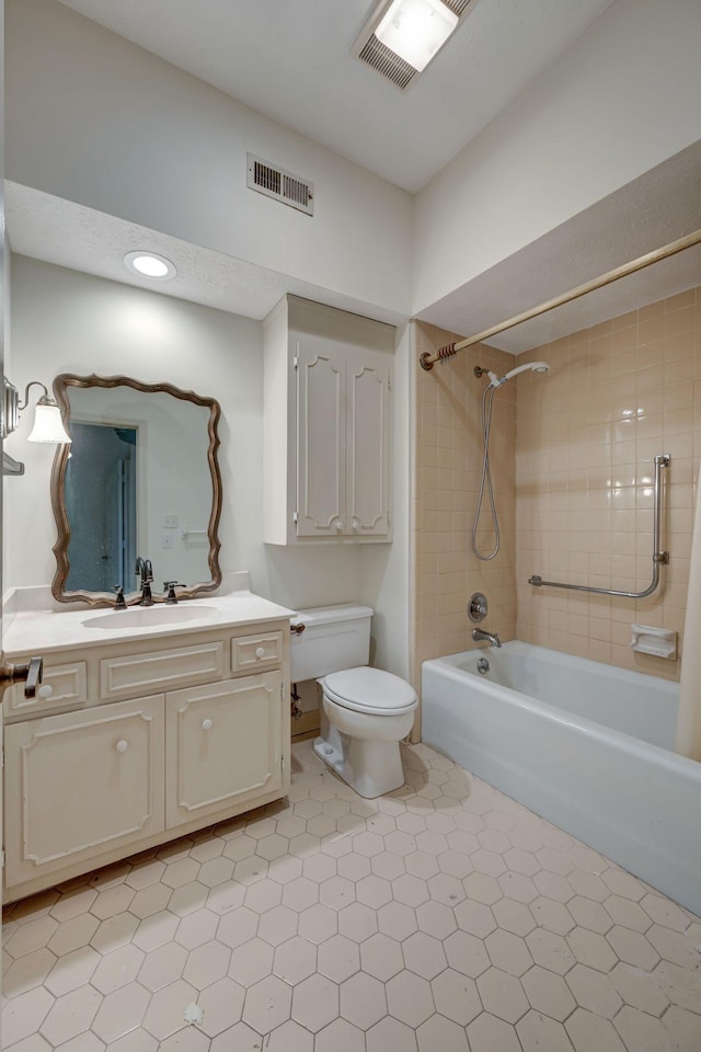 full bathroom with tile patterned floors, vanity, toilet, and tiled shower / bath combo