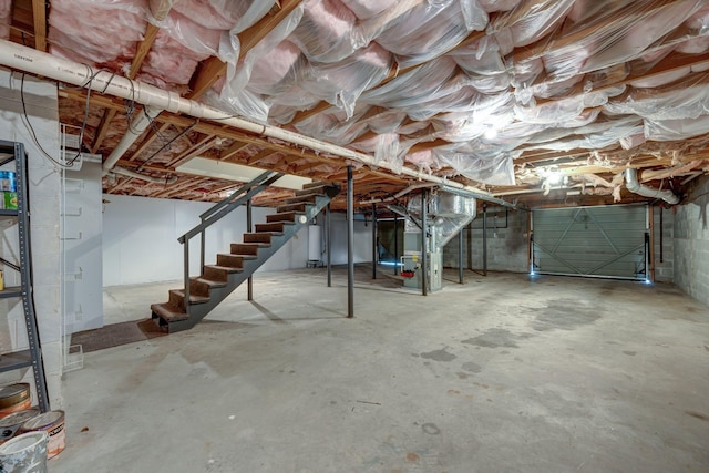 basement featuring water heater and heating unit