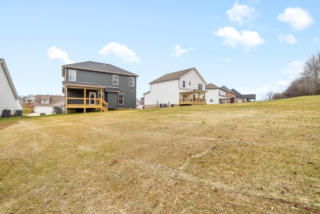 rear view of property with a yard