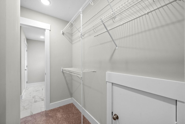 spacious closet with marble finish floor