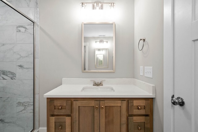 bathroom with a shower and vanity