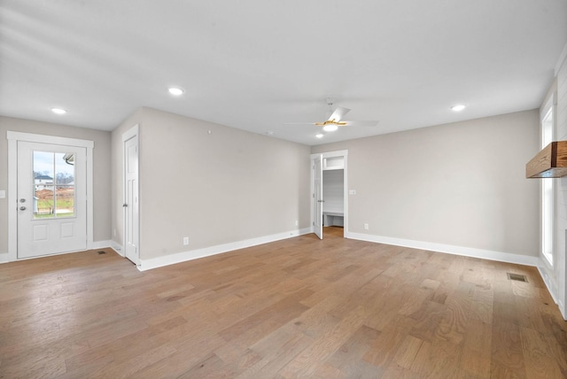 unfurnished living room featuring recessed lighting, visible vents, light wood-style flooring, and baseboards