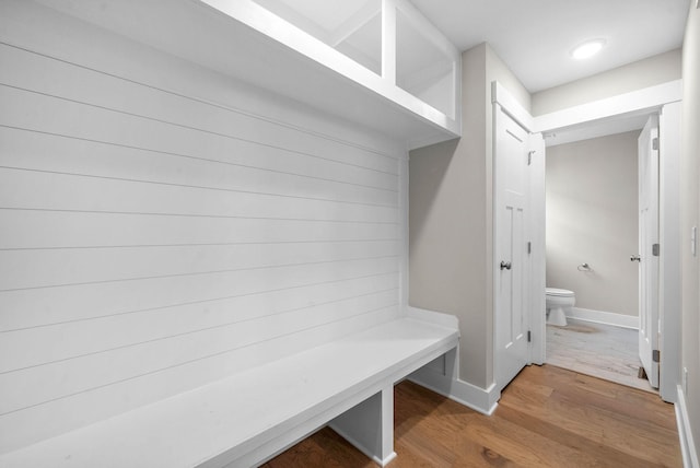 mudroom with baseboards and wood finished floors