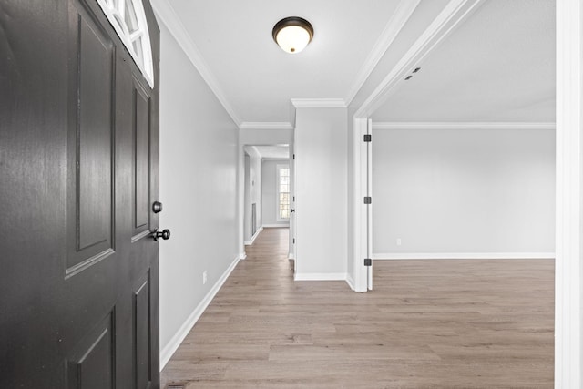 hallway with crown molding and light hardwood / wood-style flooring