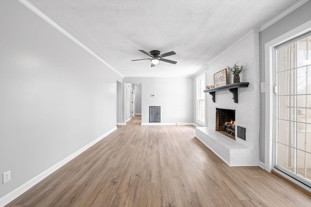 unfurnished living room with ornamental molding, a brick fireplace, and a wealth of natural light