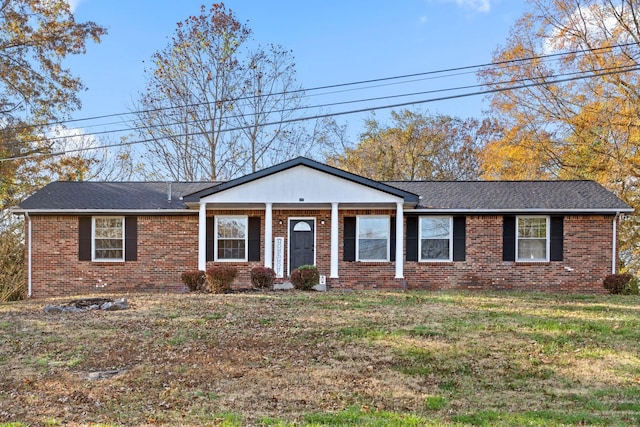 ranch-style house with covered porch and a front yard