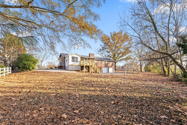 exterior space featuring a wooden deck and a patio