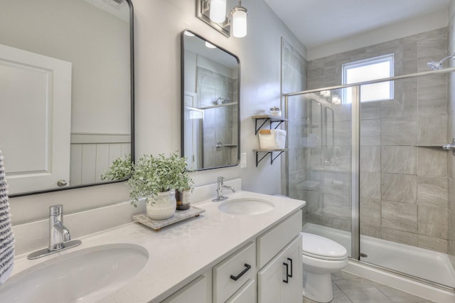 bathroom with tile patterned floors, toilet, an enclosed shower, and vanity