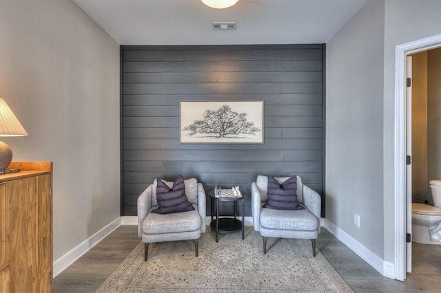 living area with hardwood / wood-style floors